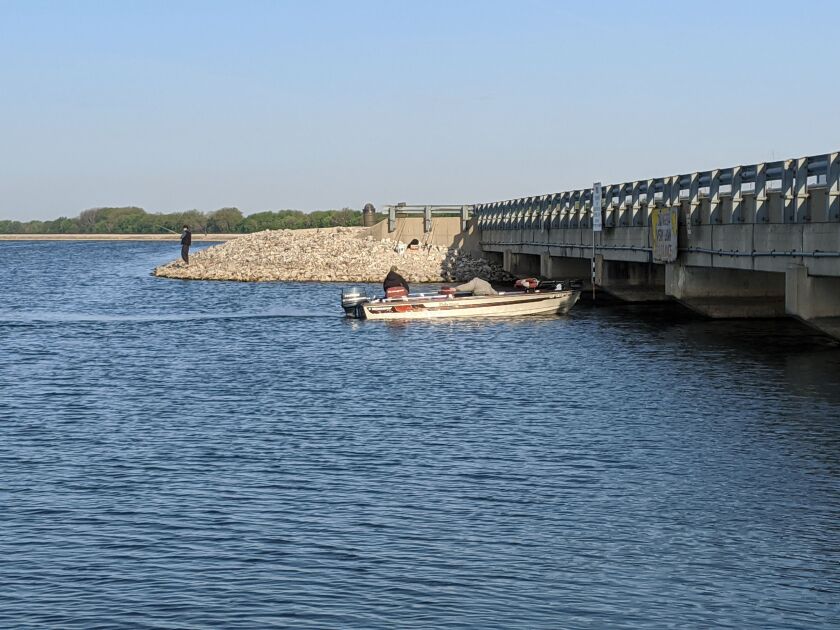 At least an angler ducking as a boat goes under the bridge at Heidecke Lake is normal. Credit: Dale Bowman