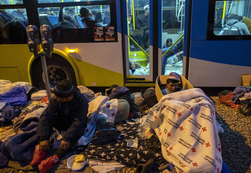 Biden on the border; Inspects busy port of entry from Mexico Migrants prepare to spend the night on a sidewalk or inside an idling city bus trying to stay warm by camping outside the Sacred Heart Church in downtown El Paso, Texas, late Saturday, Jan. 7, 2023.