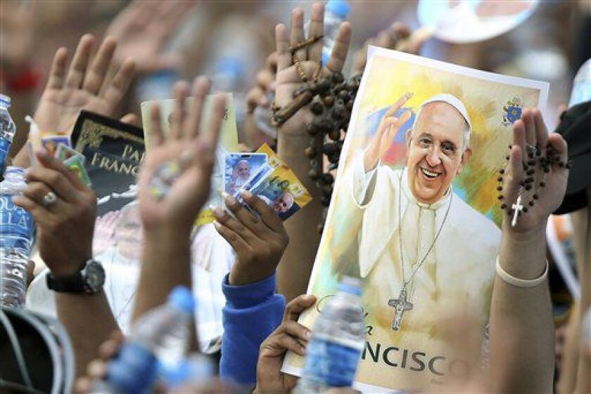 Pilgrims hold up their hands to be blessed by Pope Francis during a Mass at the Samanes Park in Guayaquil, Ecuador, on Monday, July 6, 2015. | Fernando Vergara/AP
