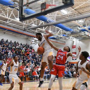 Simeon’s Jeremiah Stamps grabs a rebound over Curie’s Justin Harmon (24), Saturday 12-29-18. Worsom Robinson/For Sun-Times