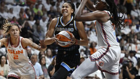 Sky forward Candace Parker drives between Connecticut Sun guard Natisha Hiedeman, left, and Jonquel Jones, right, during Game 3 of their WNBA semifinals series.