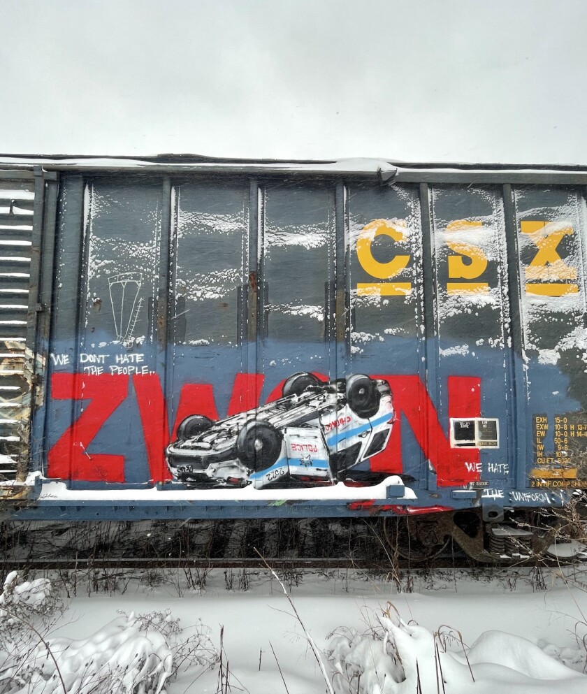 Zwon’s work on a freight train showing a flipped-over Chicago police car.