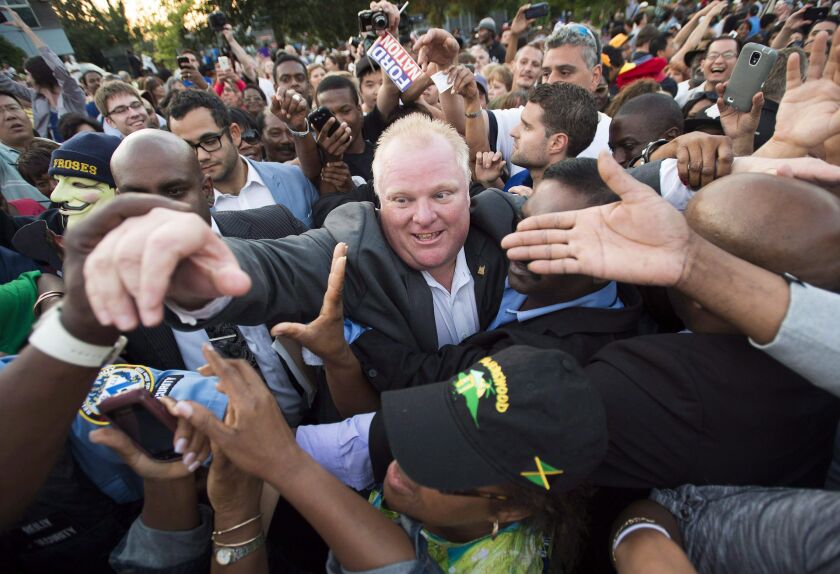 In this July 25, 2014, file photo, Mayor Rob Ford makes his way through thousands of people at Ford Fest in Toronto. Darren Calabrese / The Canadian Press via AP