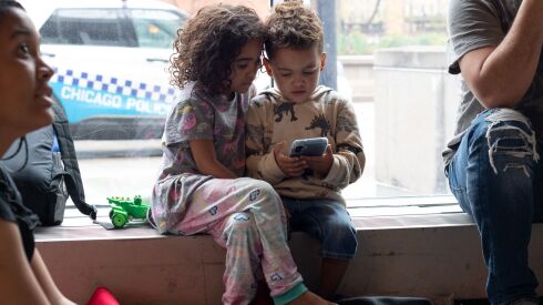 Neislymar Gonzalez’s two children, a daughter 5 years old and a son 4 years old, at the Central District police station in Chicago. Chicago’s response to a growing immigrant crisis has turned police stations into makeshift shelters for asylum-seekers.