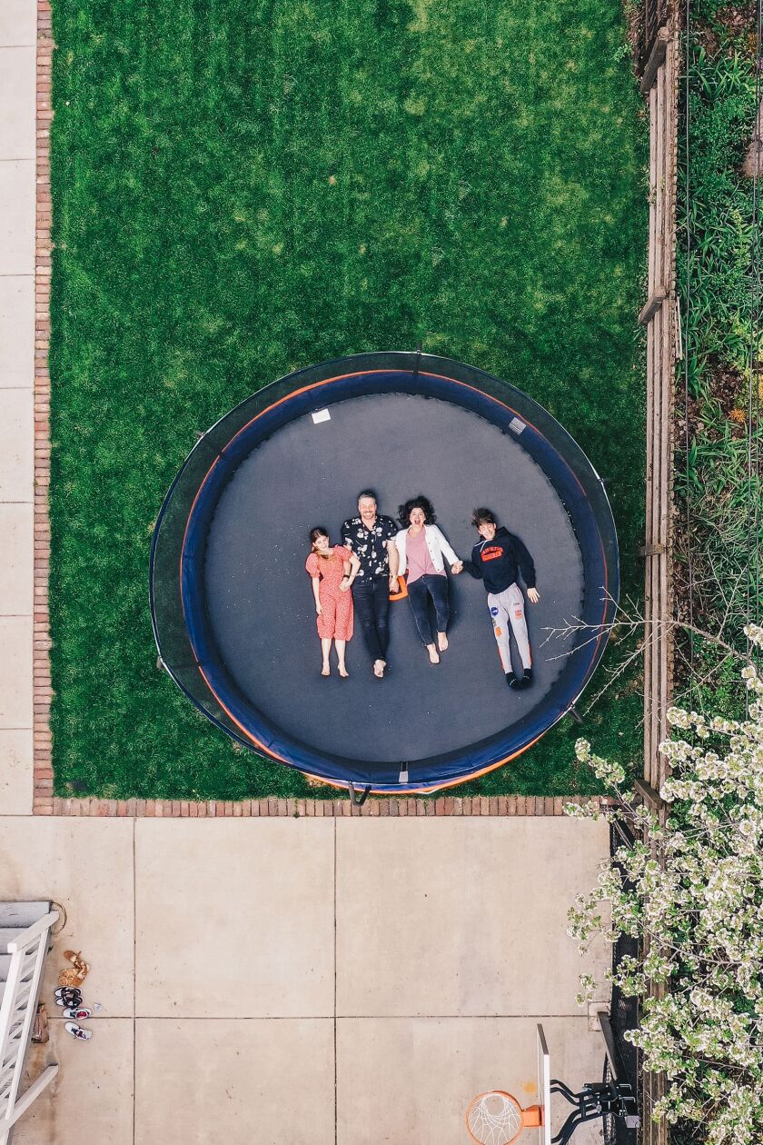 Gigi, Jarrett, Jeanne and Elijah Stevens on their trampoline in their West Loop backyard.