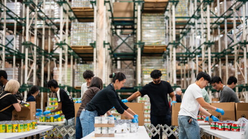 Volunteers help pack food in an assembly line-fashion at the Greater Chicago Food Depository’s warehouse in Archer Heights, Friday, Sept. 11, 2026.