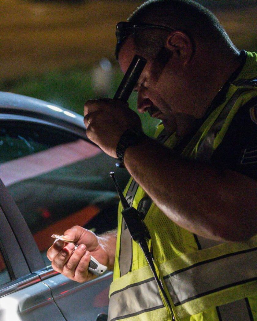 An officer cuts open what he believes is a cigarette containing marijuana during a stop in Hammond, Indiana in 2014. | Jim Karczewski/Sun-Times file