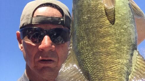 Matt Mullady with a smallmouth bass from the Kankakee River. Provided photo