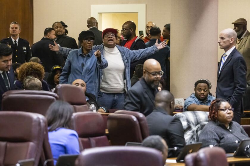 Members of the public shout during a Chicago City Council Rules Committee on Nov. 7, 2023.