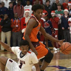 Bro. Rice’s Marquise Kennedy (24) spins off St. Rita’s Joel Watts (3) Tuesday 12-04-18 Robinson/For Sun-Times