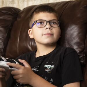 Oliwier “Oli” Kluzik, 12, plays Minecraft at his grandmother’s Northwest Side home