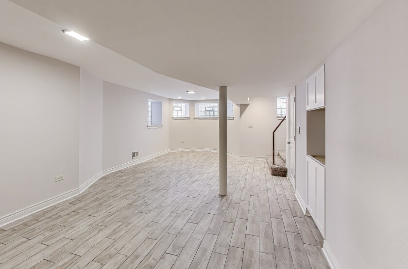 Lower level that has a family room and cabinets