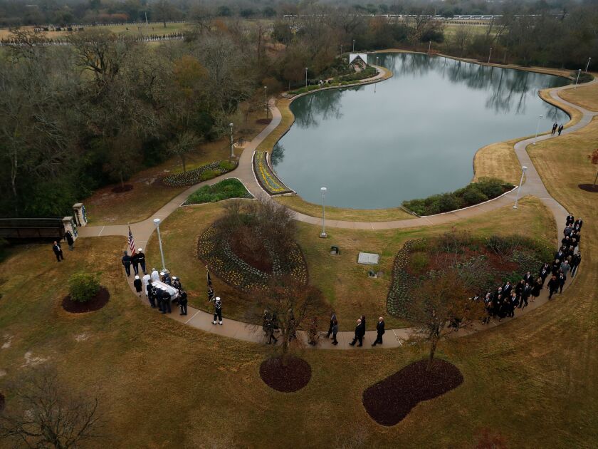 The flag-draped casket of former President George H.W. Bush is carried by a joint services military honor guard followed by family members at the George H.W. Bush Presidential Library and Museum on Dec. 6, 2018 in College Station, Texas. | Jeff Roberson-P