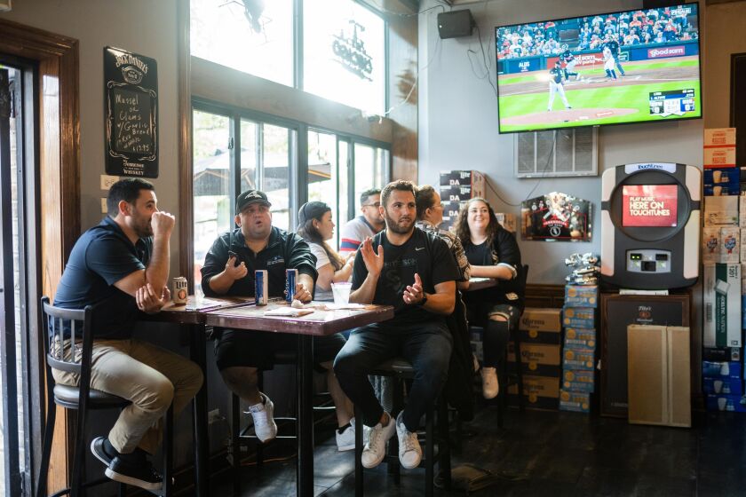White Sox fan Anthony Ciaravino says the sounds of stadium fireworks are like second nature to him. This year, he said he’s hopeful the Sox will win it all. White Sox fan Anthony Ciaravino, in black, claps while watching the first game of the American League Division Series between the Chicago White Sox and Houston Astros at Turtle’s Bar and Grill in the Bridgeport neighborhood, Thursday afternoon, October 7, 2021.