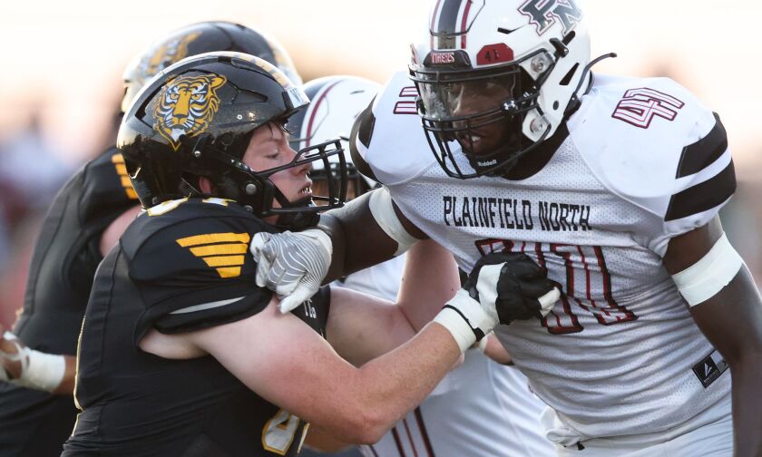 Plainfield North’s Gerald Floyd, facing, tries to work around the block of Joliet West’s Tanner Brooks.