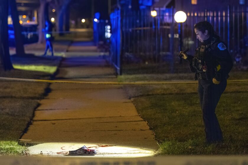 Chicago police investigate in the 9300 block of South Racine Avenue after three teenage boys were among four people shot and wounded during an argument in the Brainerd neighborhood, Monday, Dec. 11.