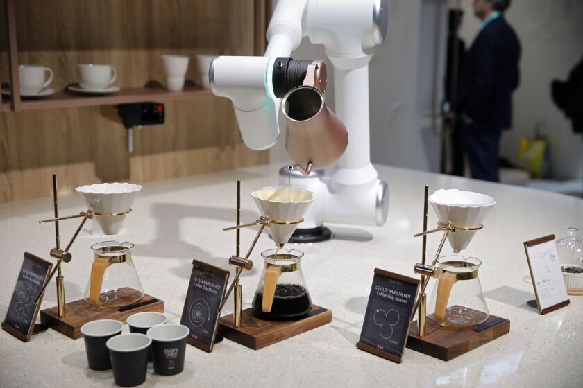 A LG CLOi CoBot Barista makes coffee in a mock restaurant setting at the LG booth during the CES tech show, Tuesday, Jan. 7, 2020, in Las Vegas