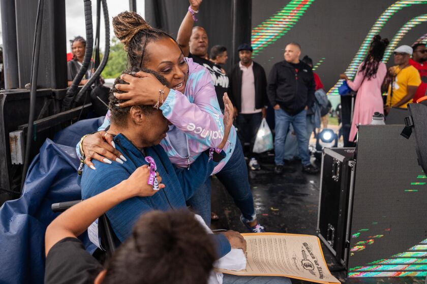 DJ Jesse Saunders, a Chosen Few DJ, receives a hug as he gets emotional while reading a proclamation that had been presented by Lt. Gov. Juliana Stratton during the Chosen Few Picnic at Jackson Park in the Woodlawn neighborhood, Saturday, July 8, 2023.