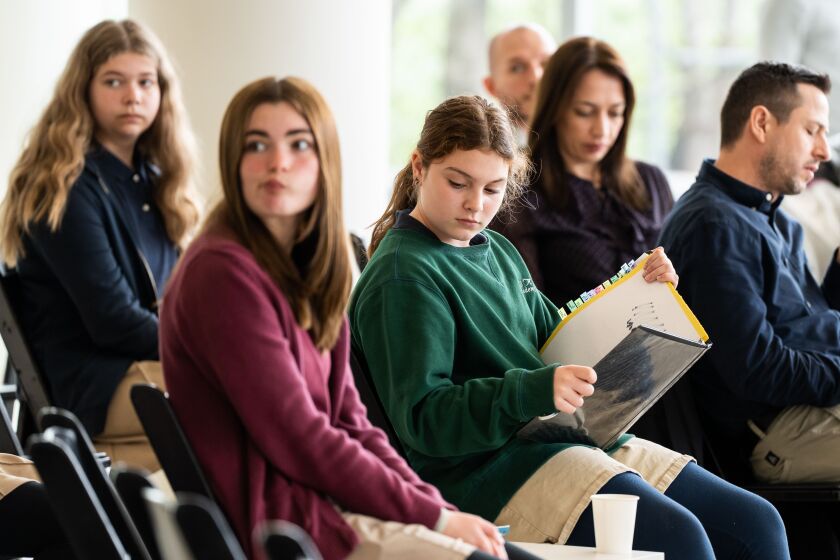 Izzy Bruscianelli (in green), 12, who is a sixth grader at Plato Academy, reads during “Homerathon,” a two-day event where volunteers read parts of Homer’s “The Odyssey” aloud at the National Hellenic Museum in the Greektown neighborhood, Friday, April 21, 2023. | Pat Nabong/Sun-Times