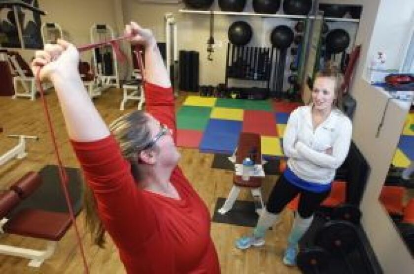 <em><strong>Trainer Nicolette Isaacs works with Barling at the Fitness Connexion in Bloomington. | David Proeber/AP/The Pantagraph</strong></em>