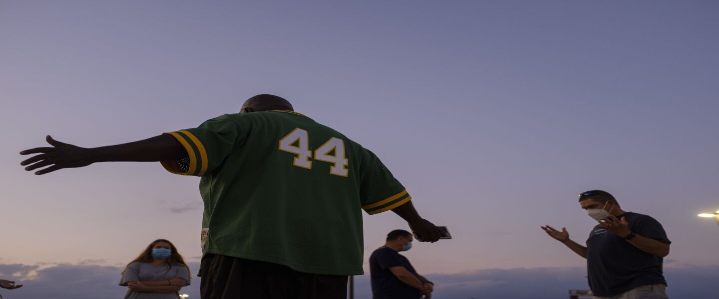 Pastor Donavon Price during a prayer circle in a parking lot at a strip mall on the South Side. During the summer, Price holds prayers every Monday for victims of violence and their families.
