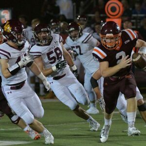 Brother Rice’s quarterback John Bean (2) scrambles. Worsom Robinson/For the Sun-Times.