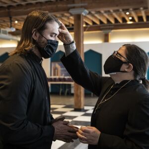 Pastor Ben Adams, of Holy Trinity Lutheran Church, receives the imposition of ashes from the Rev. Amity Carrubba at Grace Episcopal Church of Chicago in the South Loop on Ash Wednesday, Feb. 17, 2021.