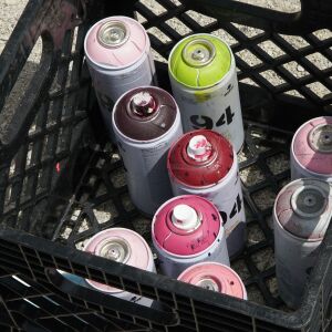 Spray paint cans Joseph Renda is using to paint a mural on the side of Chilango, a Mexican street food restaurant at 1437 W. Taylor St.