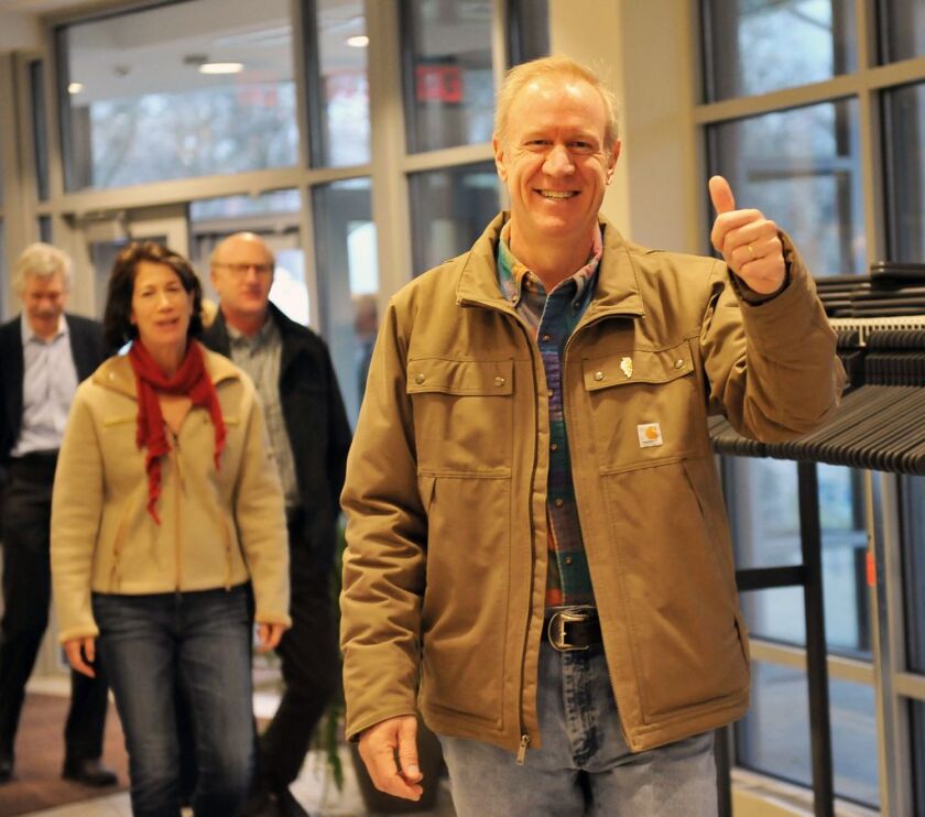 Then-Republican gubernatorial candidate Bruce Rauner and his wife Diana arrive at their Winnetka polling place in 2014. File Photo. | Al Podgorski / Sun-Times Media