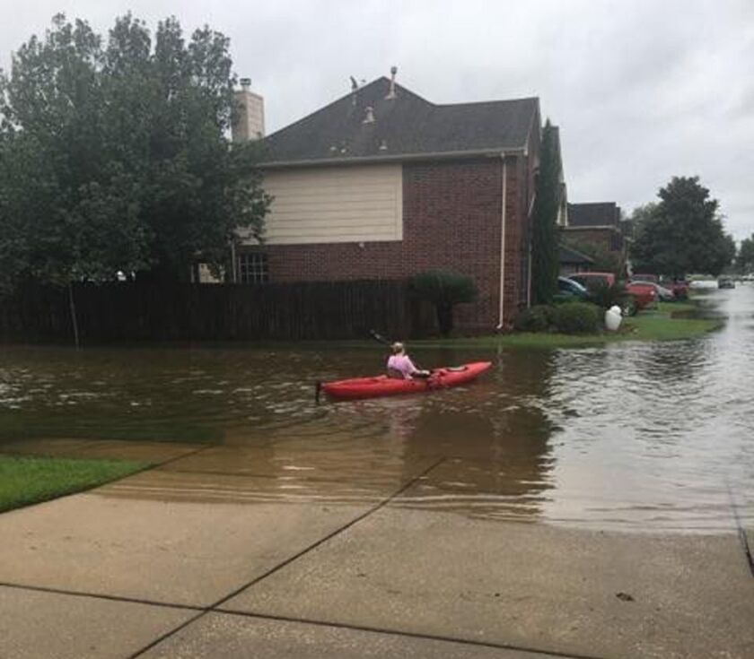 A former Downers Grove area resident texted friends pictures showing residents of her flooded neighborhood in Pearland, Texas using kayaks to get around. | Provided