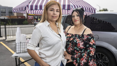 Laura Murillo and Gina Otamendi stand in front of Murillo's old tamale stand.