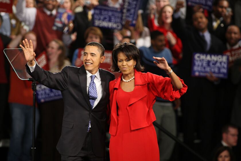 Barack Obama and his wife Michelle take the stage at the Hyatt Hotel February 5, 2008 in Chicago.