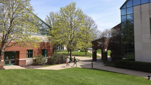 Students walk toward the entrance of a brick building on campus at Trinity Christian College, 6601 W College Drive.