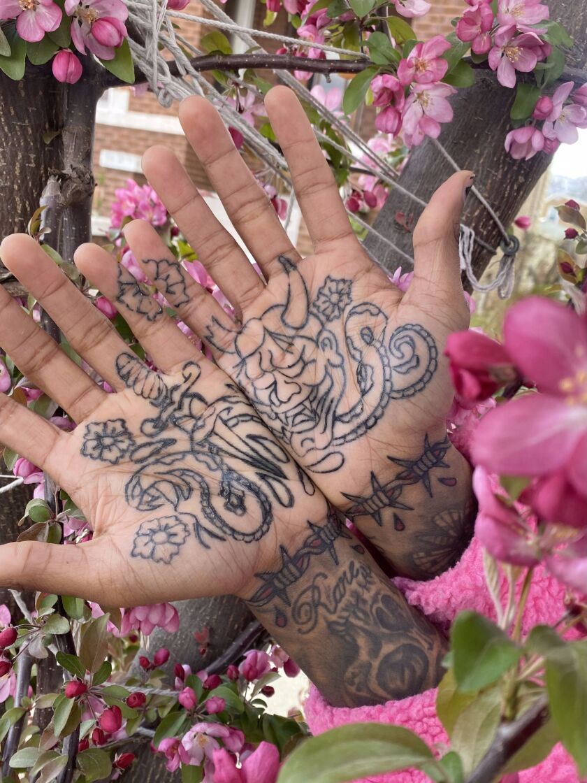 Nico Roberts’ palm tattoos include a snake and dagger and a Hannya mask.