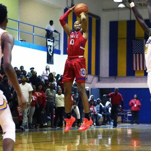 Curie’s Josiah Hammons (10) attempts a shot against Simeon.