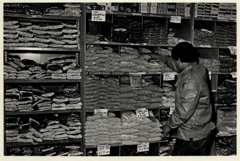 Stocking shelves at Patel Brothers store, 2542 W. Devon Ave., in November 1984