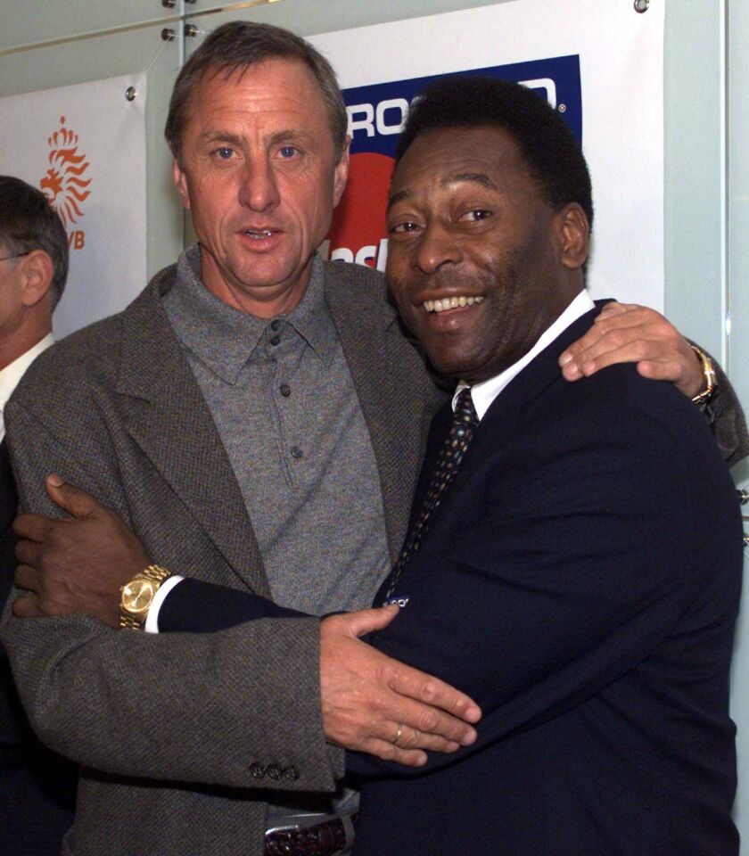 This Oct. 8, 1999, photo shows Dutch soccer legend Johan Cruyff, posing with Brazilian soccer legend Pele in Amsterdam. AP file photo