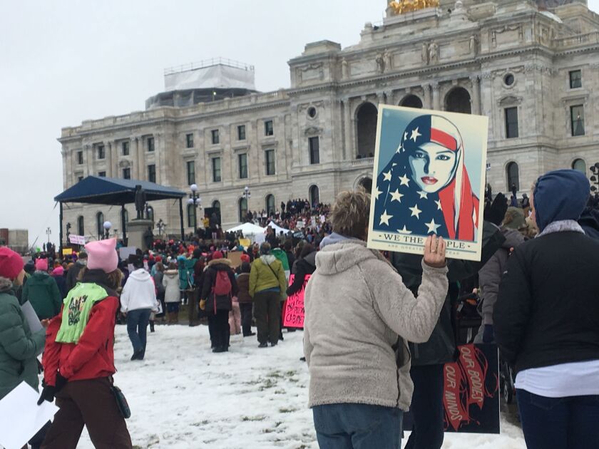 A protester holds sign at Minnesota Women’s March in front of the state Capitol in St. Paul, Minn., on Saturday. The march was held in in conjunction with with similar events taking place around the nation following the inauguration of President Donald T