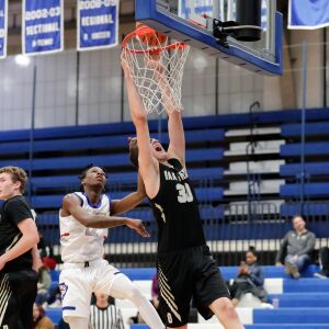 Oak Forest’s Robbie Avila (30) dunks the ball against Crane.