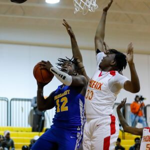 Farragut’s Mikqwon Jones (12) goes to the basket against North Lawndale’s Christian Miller (33).