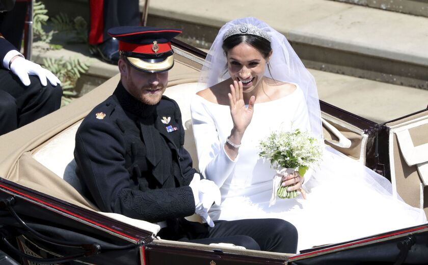 Britain’s Prince Harry and Meghan Markle leave after their wedding at St. George’s Chapel in Windsor Castle in Windsor, near London, England, Saturday, May 19, 2018. (Andrew Matthews/pool photo via AP)
