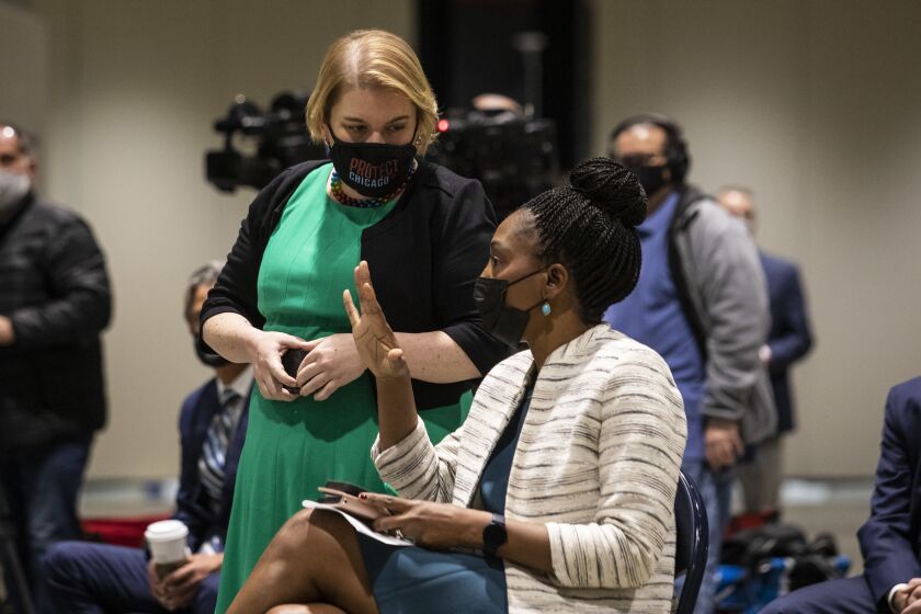 Dr. Allison Arwady, commissioner of the Chicago Department of Public Health, chats with Dr. Ngozi Ezike, director of the Illinois Department of Public Health, Tuesday morning.