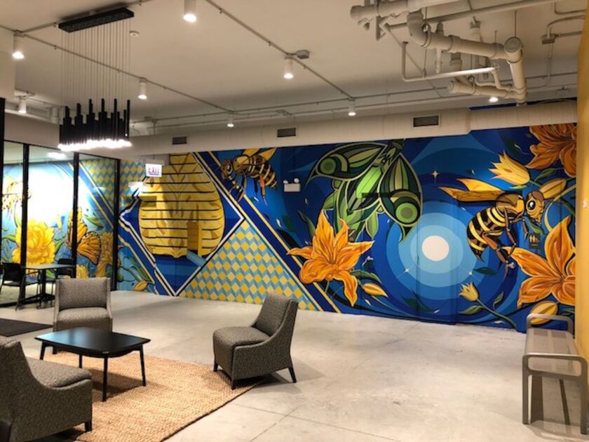 Miguel Del Real painted this mural, titled “Community Diligence,” in the entrance of an affordable housing development in Albany Park. It depicts insects working together, signifying community collaboration.