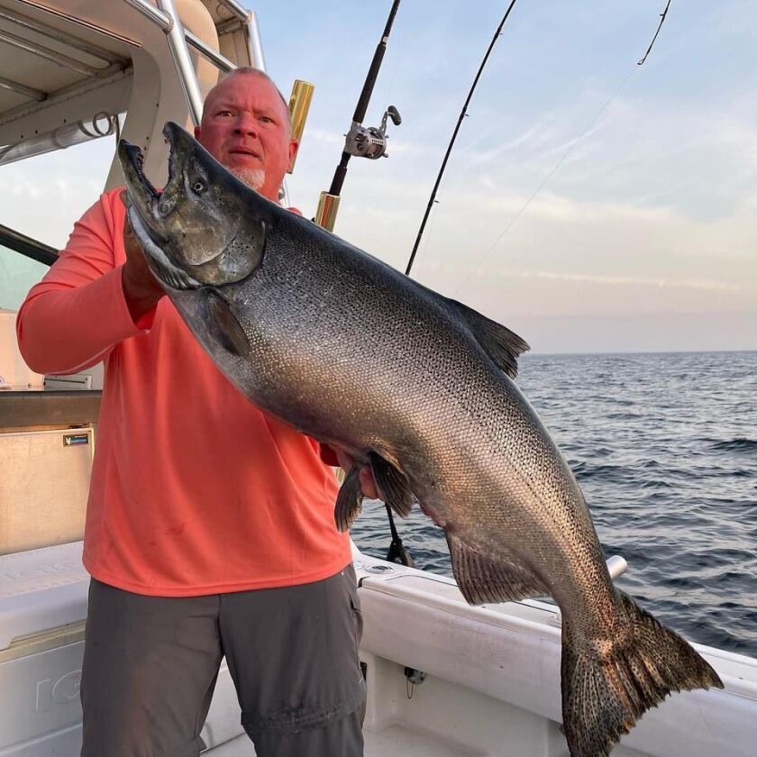 A full-length view of Capt. Bob Bachler with a Chinook big enough to consider the Illinois record. Provided photo