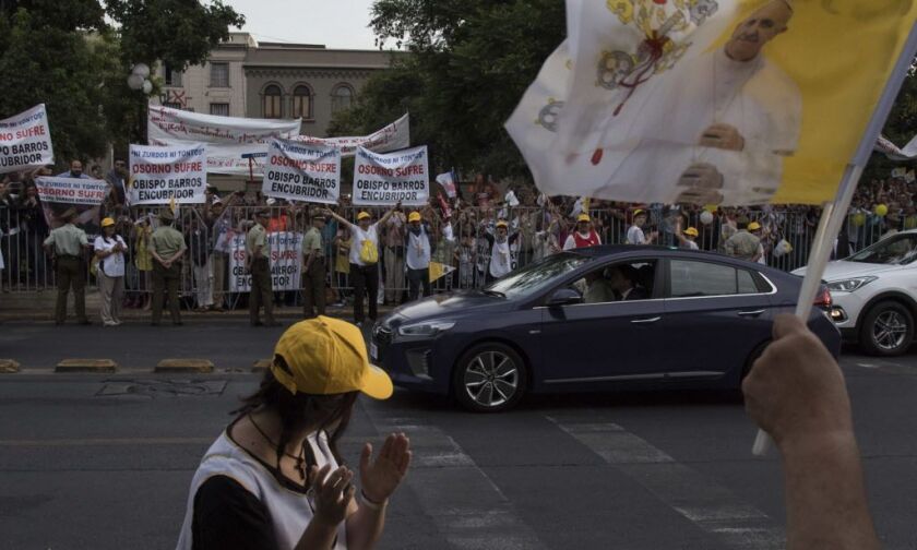 Demonstrators protest against the Catholic church and the visit of Pope Francis as Pope Francis drives by, in Santiago, Chile, on Monday, Jan. 15, 2018. | Aliosha Marquez/AP photo
