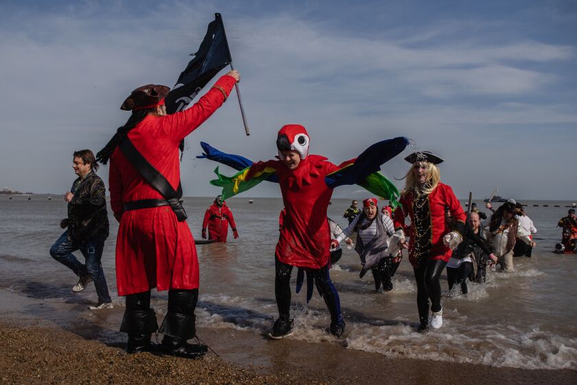 People dressed in pirate-themed costumes dive into the frigid waters of Lake Michigan at North Avenue Beach for the 20th annual Chicago Polar Plunge to benefit Special Olympics Chicago, Sunday morning, March 1, 2020.