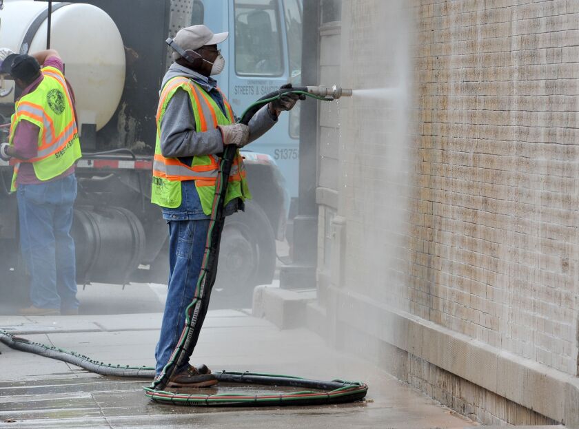 City workers are shown removing graffiti in Chicago’s Pilsen neighborhood in 2013. | Al Podgorski~Chicago Sun-Times