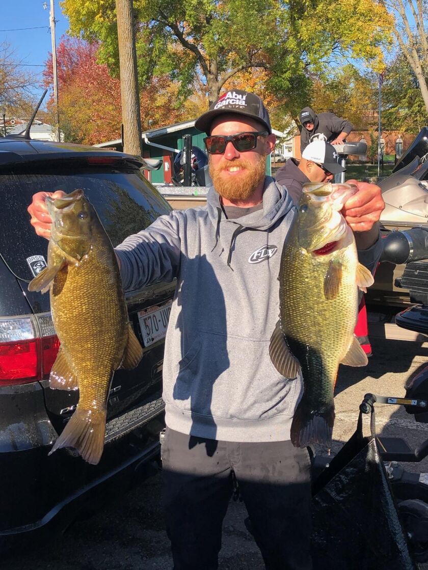 Ryan Whitaker of Chicago with two 5-pound bass caught from Big Green Lake last Sunday. Provided by Mike Norris