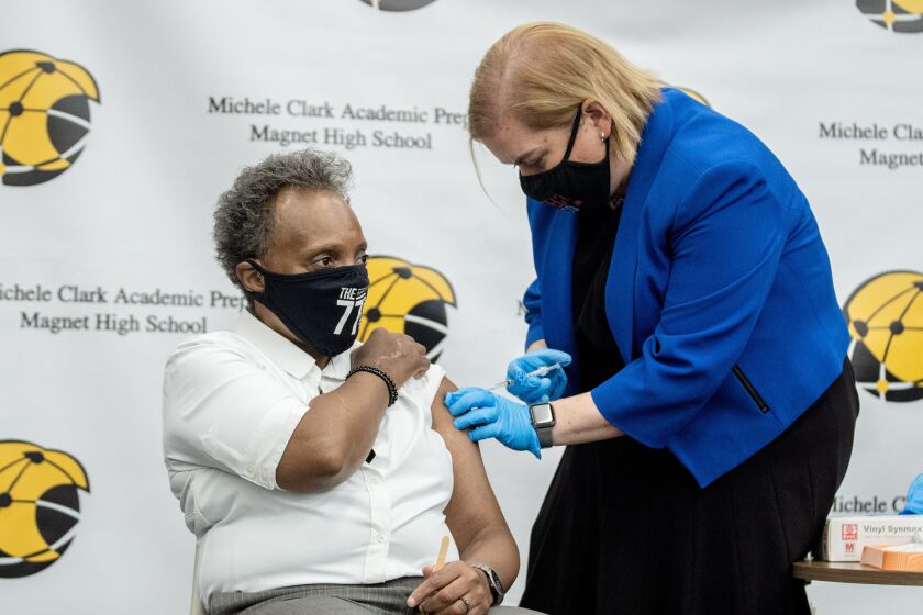 Mayor Lori Lightfoot gets a booster shot Friday.