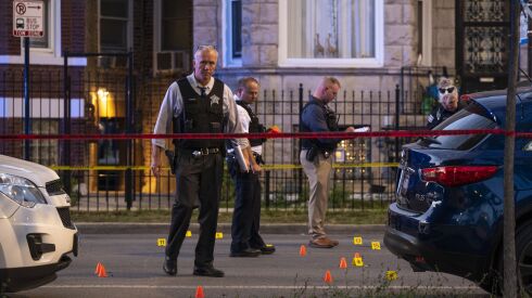 Chicago police officers at the scene of a fatal shooting of a 24-year-old man last Sept. 2 in the 4400 block of West Jackson Boulevard in West Garfield Park. A new study describes the neighborhood during the COVID-19 pandemic as deadlier than a war zone.
